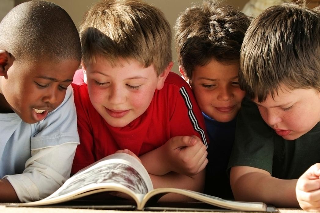 Children happily reading a book together