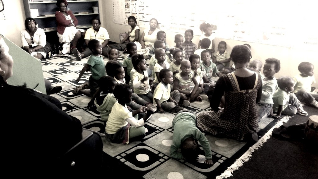 Literacy mentor storytelling to a group of little children